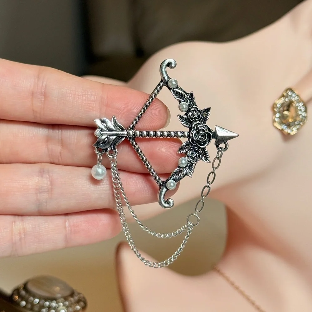 Elegant Silver Bow and Arrow Brooch